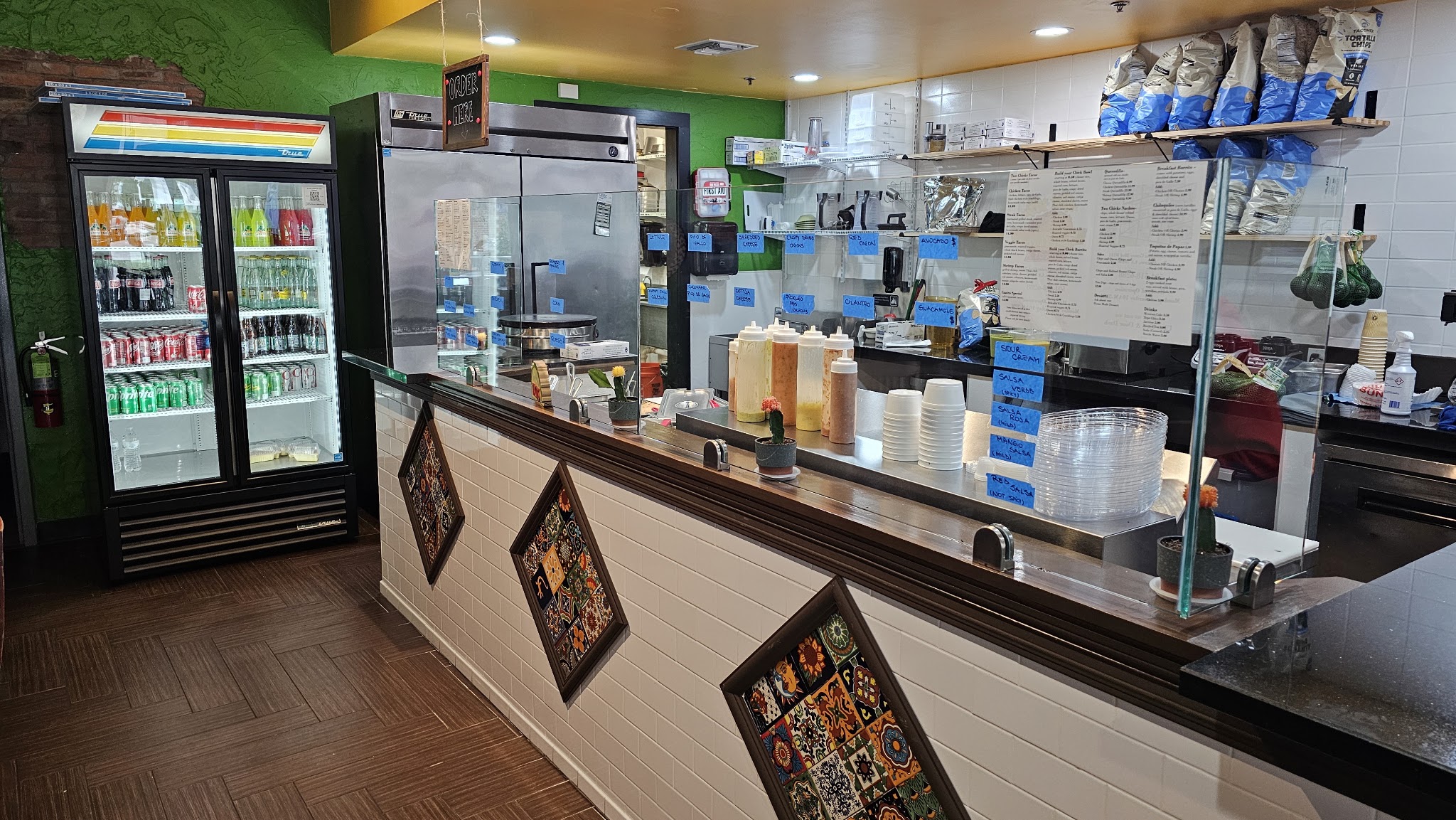 Counter salsa and condiment station with menu board