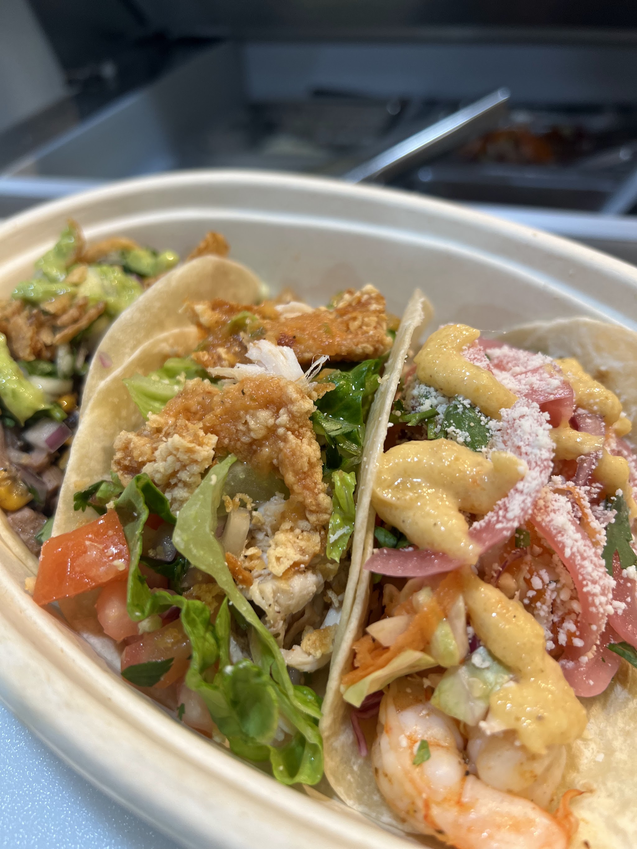 Close-up of fried chicken and shrimp tacos