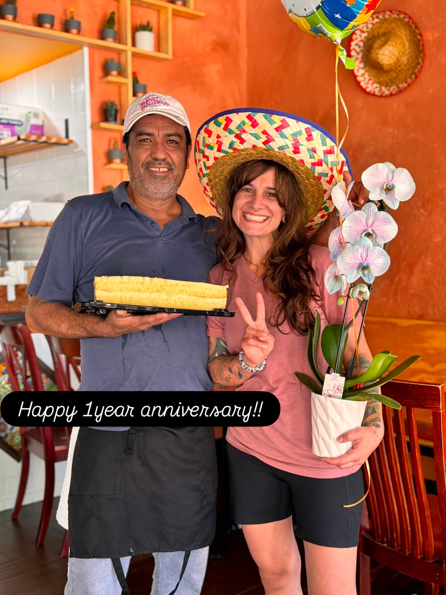 Two Chicks Tacos staff celebrating the restaurant's 1-year anniversary with a cake