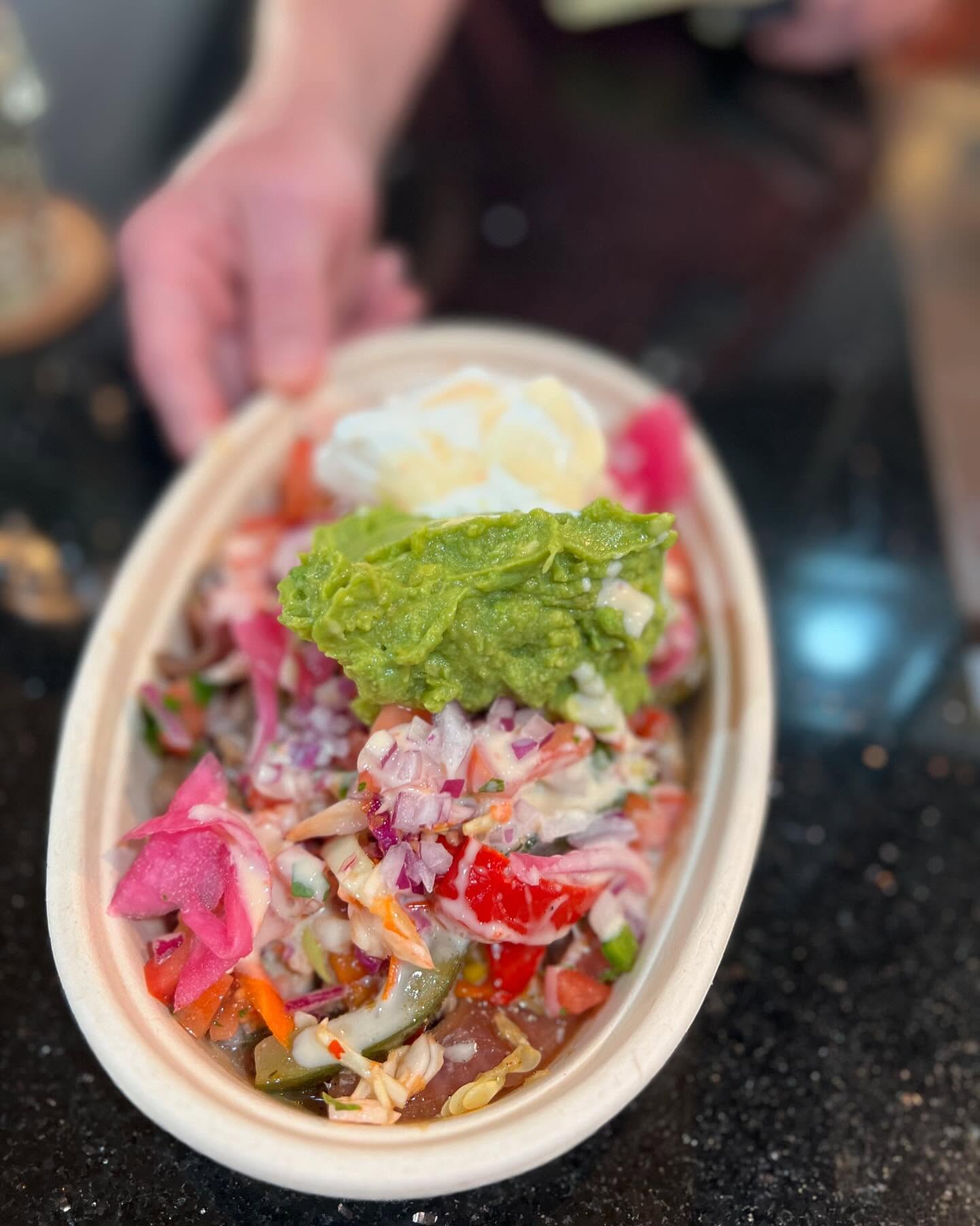 Loaded bowl with guacamole, pickled onions and pico de gallo